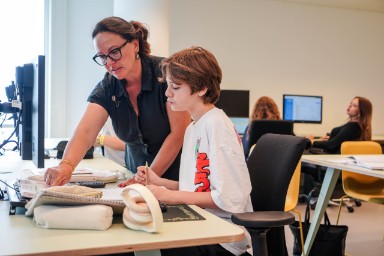 Op de afbeelding Docent en vrijwilliger Huiswerkbegeleiding Bibliotheek Bouwlust